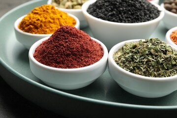 Different aromatic spices on grey table, closeup
