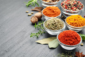 Different aromatic spices on grey table, closeup. Space for text