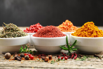 Different aromatic spices on wooden table, closeup
