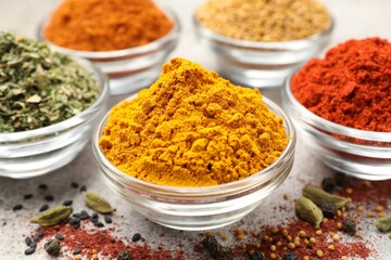 Different aromatic spices on light grey table, closeup