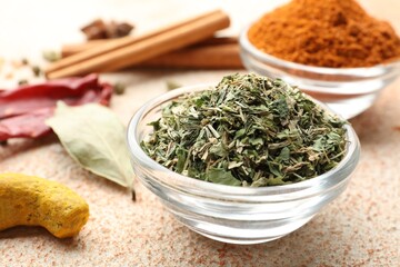 Different aromatic spices on color textured table, closeup
