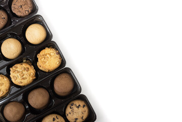 Various round cookies in an open box. Cookies in a pack on white