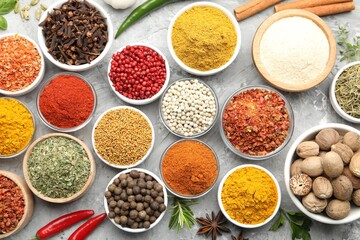Different aromatic spices on grey table, flat lay