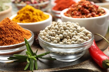 Different aromatic spices in bowls on table, closeup