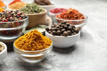 Different aromatic spices on grey table, closeup. Space for text