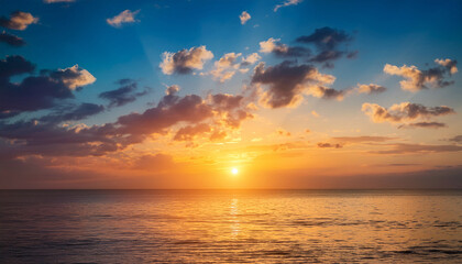 sunset sky vertical in the morning with blue and orange yellow sunrise and clouds fluffy horizon sea golden hour summer background