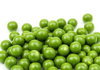 Heap of vibrant green peas on a white surface, close-up view