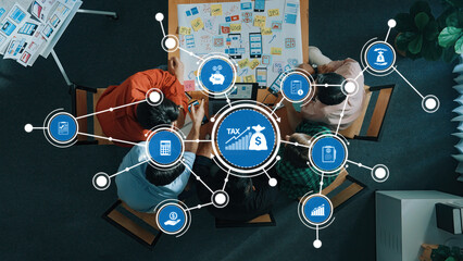 A diverse team collaborates on tax strategy in a modern office, utilizing visual data tools to enhance their brainstorming and planning sessions for effective financial solutions. Amity