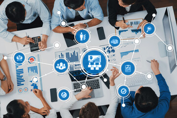 A group of professionals engaged in a strategic meeting, utilizing data visualization and analytics...