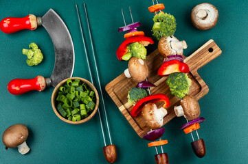 Tasty kebab on skewers with vegetables.