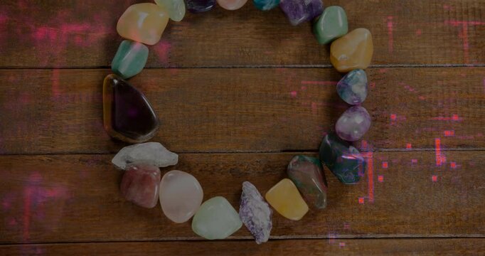 Showcasing open gemstone circle forming on wooden tabletop, highlighting polished colorful stones