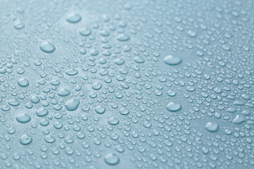 Many water drops on light blue background