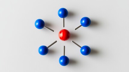 Obraz premium One red pin stands out among five blue pins arranged in a circle on a white background. This shows teamwork, being different, and leading. 