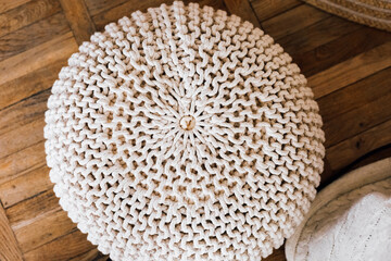Cozy knitted pouf adds warmth to living space with rustic charm