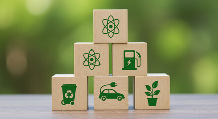 Stacked wooden blocks displaying green environmental icons against a blurred green background