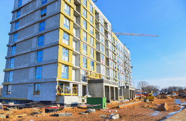 Construction site, Multi Storey Residential Buildings construction. Facade Insulation. Building construction. Construction crane on Housing. Modern Residential home building. Modern House building.