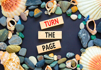 Turn the page symbol. Concept words Turn the page on beautiful wooden block. Sea stones and shells....