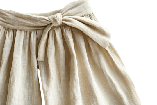 Elegant beige textured pants with a bow detail soft fabric closeup view stylish summer fashion