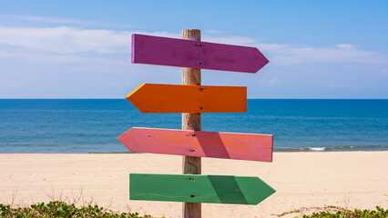 Colorful Beachside Wooden Directional Sign Post Ocean Coastline