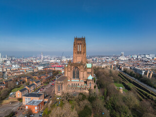 Obraz premium Aerial view of Liverpool highlighting the Gothic Revival Liverpool Cathedral, tree lined streets, residential areas, and the distant waterfront.