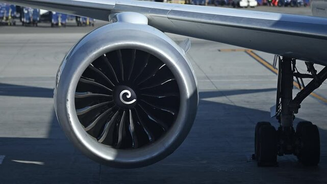 Close-Up View of Jet Engine and Landing Gear of Parked Commercial Aircraft on Airport Apron in Morning Light