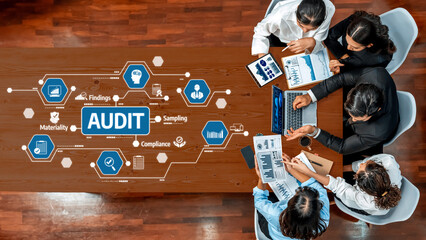 A diverse team engages in an audit meeting discussing compliance, materiality, and sampling strategies, emphasizing collaboration in a modern office setting. Amity