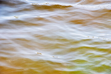 Background of the Dnieper River water surface with ripples. River water in autumn in the rays of...