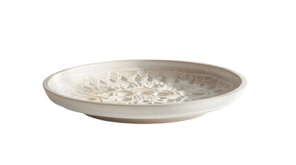 A low angle shot of an ornate white decorative plate with floral designs against a  transparent background 