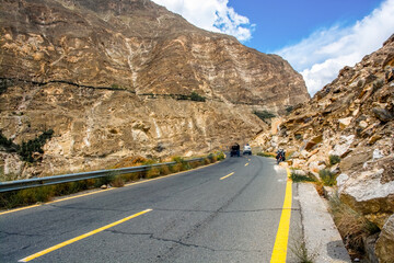 The Karakoram Highway winds past jagged ice cones and ancient glaciers, with the icy waters of the Hunza River roaring below