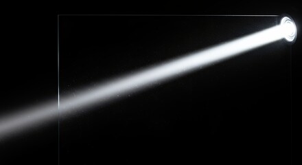 Diagonal bright light beam on dark background
