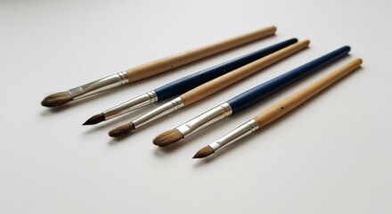 Artist's Paintbrush Collection - Five assorted paintbrushes, showcasing various sizes and shapes, ideal for diverse painting techniques. Symbolizing creativity, artistry, precision, expression