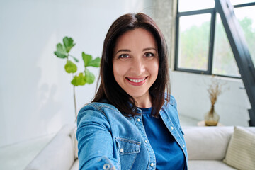 Selfie portrait happy beautiful woman in home interior