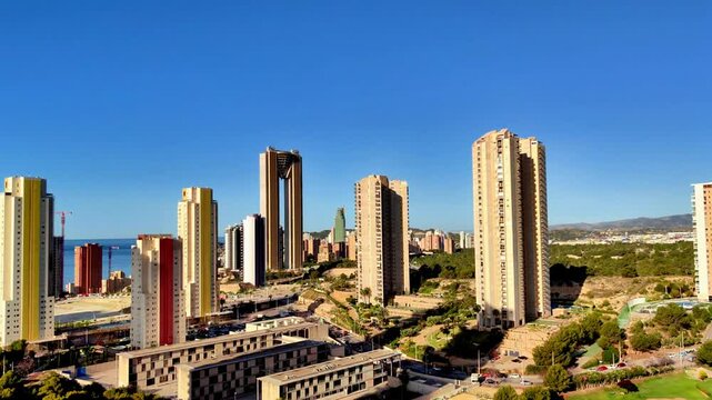 A breathtaking view showcasing a vibrant coastal city, featuring modern highrise buildings against a clear blue sky