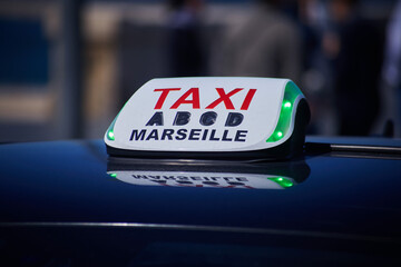 French Marseilles Taxi sign close-up view with the street view with the unfocused depth of field background