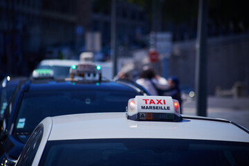 French Marseilles Taxi sign close-up view with the street view with the unfocused depth of field background