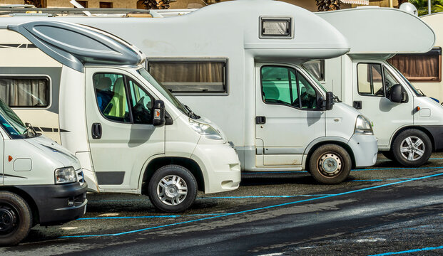 campers and motorhomes on asphatl parning, white auto caravan for  vacation travel