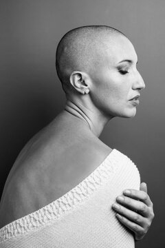 Black and white portrait of a middle aged woman with shaved head
