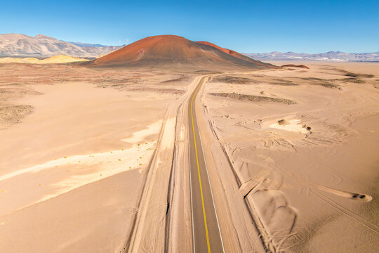 Endless road through a desert landscape with mountain in the Puna