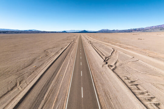Endless Road Through Desert Under Clear Blue Sky in the Argentine Puna