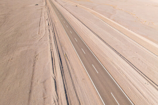 Aerial view of a long straight road through in the argentine Puna