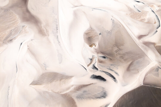 Aerial view of abstract desert patterns whit dunes in soft tones