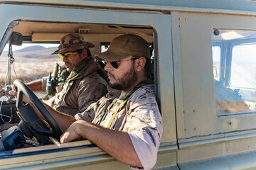 Military Personnel in Vehicle on Patrol in the Desert