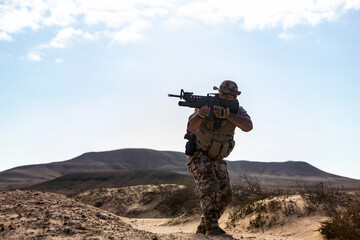Soldier in desert camouflage during tactical operation
