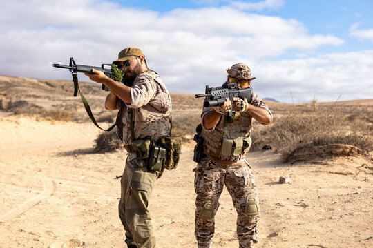 Desert military training with armed soldiers in tactical gear