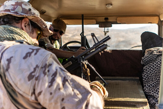 Tactical team in military vehicle during desert operation
