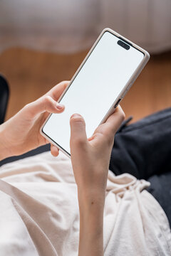Teen Boy Engaged in Mobile Gaming on Smartphone