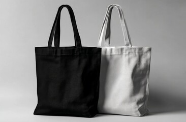 A grey background features a mockup of white and black tote bags