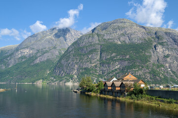 Fototapeta premium Peaceful fjord landscape in Norway, featuring towering green mountains.