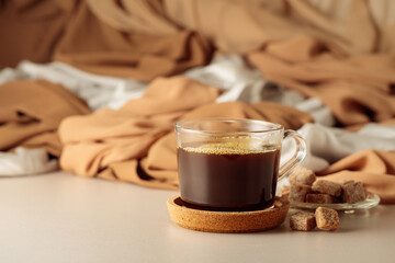 Black coffee in glass cup and brown sugar.