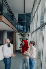 Diverse business team discussing strategy in modern office building